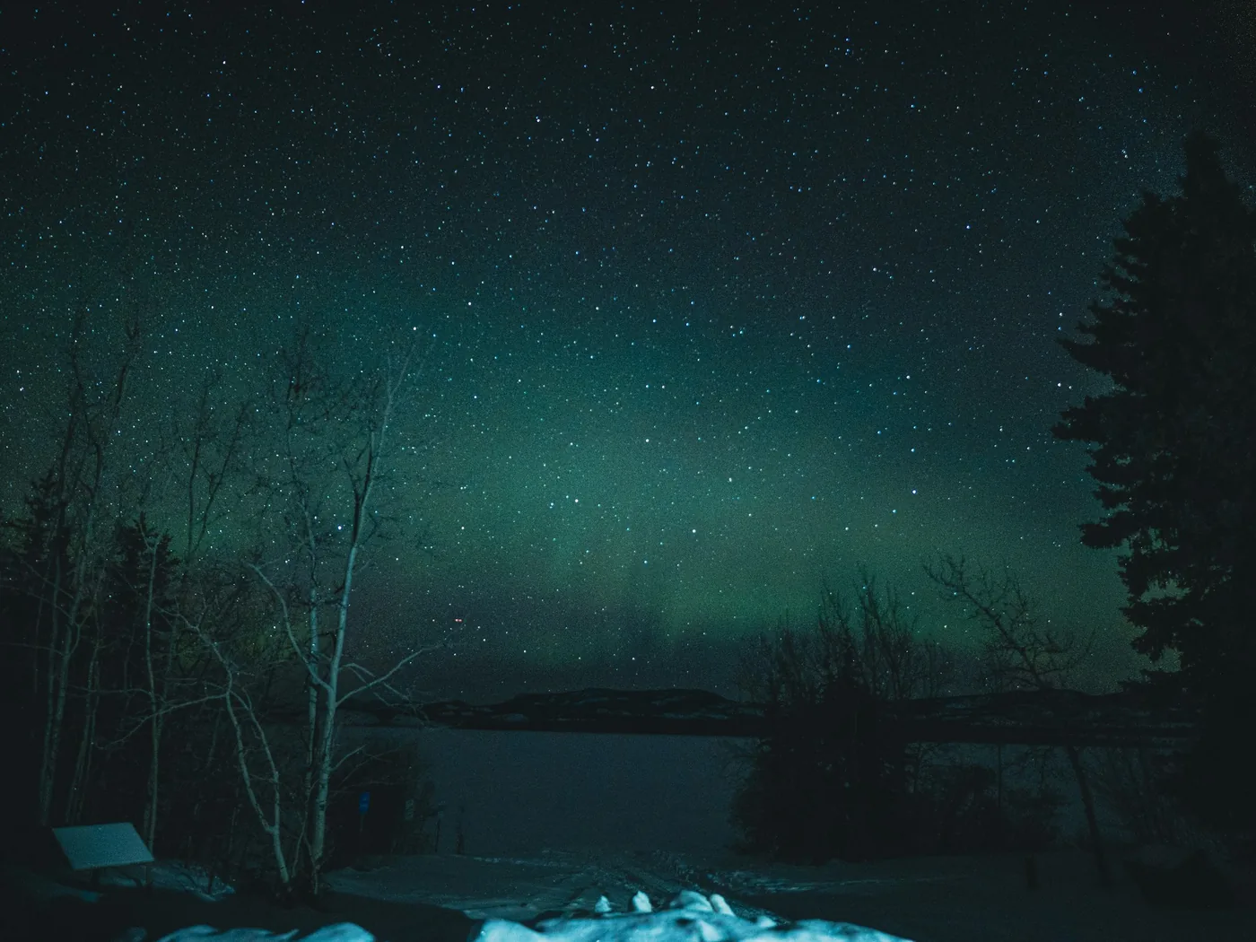 A small campfire glowing in the Arctic snow at night